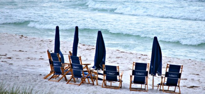 blue beach chairs on white sand