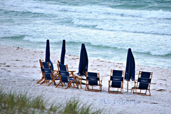 blue beach chairs on white sand