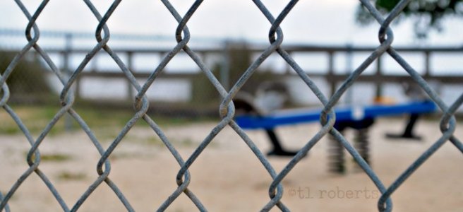 view of playground through chain link fence