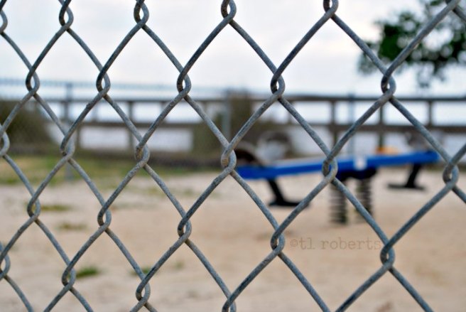 view of playground through chain link fence
