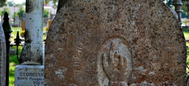 gravestone with pointing finger