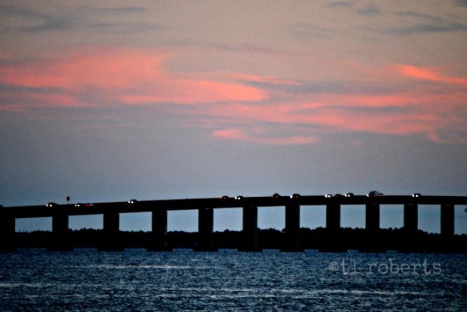car lights on bridge at sunset