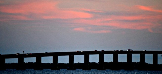 car lights on bridge at sunset