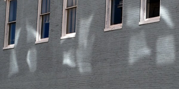 sunlight reflected on grey building