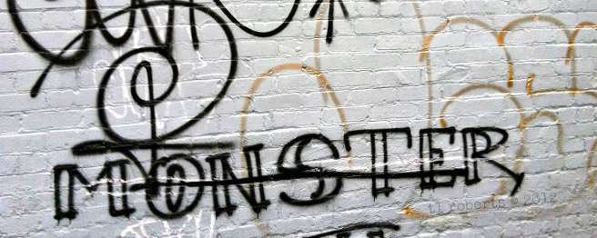 monster graffiti on white brick wall