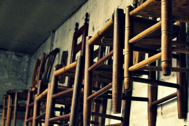 wooden chairs hanging on a wall