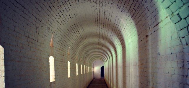 narrow white brick passage