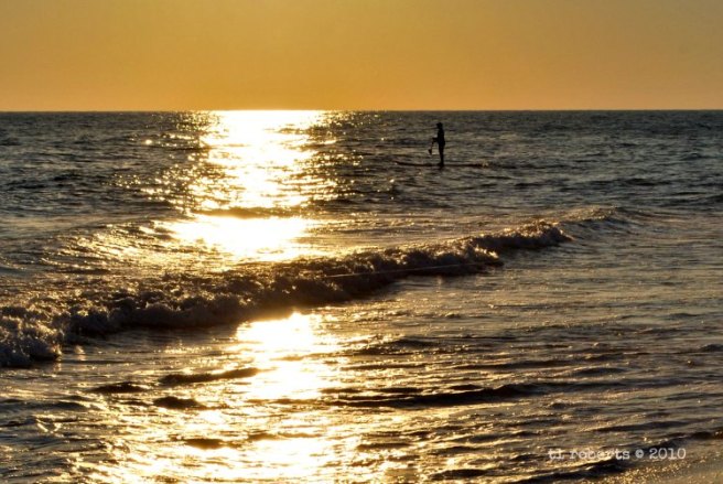 paddle boarding at sunset