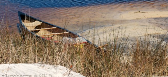 grounded canoe on sandy bank