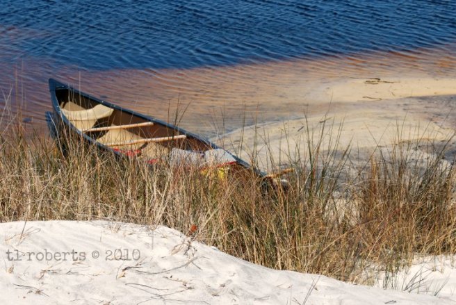 grounded canoe on sandy bank